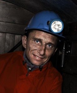 Coal miner wearing helmet with light