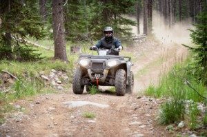 Riding ATV on dirt road